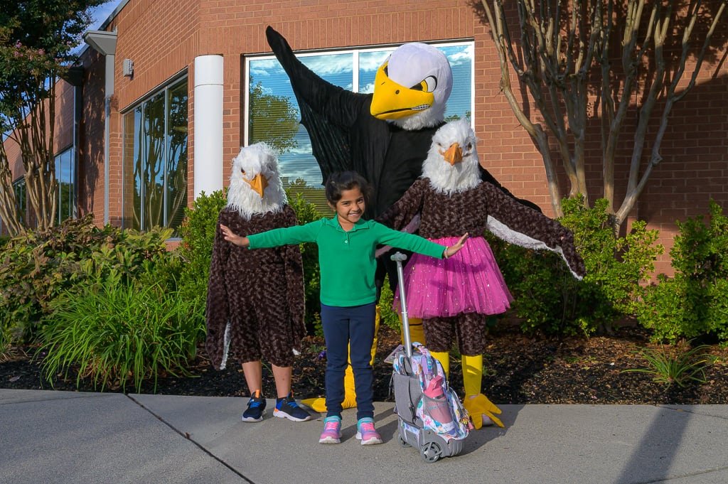 Nysmith mascot, Sparky, welcomes students to school