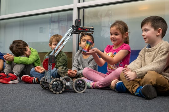 Preschoolers play with robots
